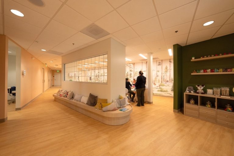 Modern office interior with seating and meeting area.