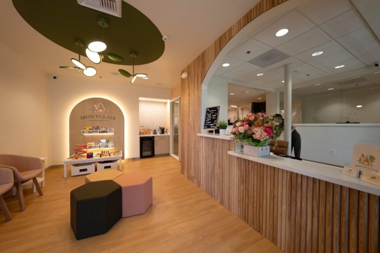 Pediatric clinic reception area with seating and toys.