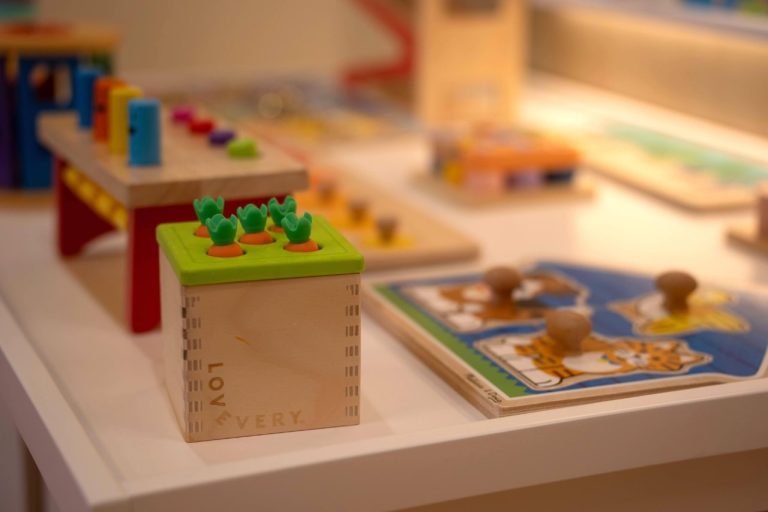 Colorful educational wooden toys on display table.