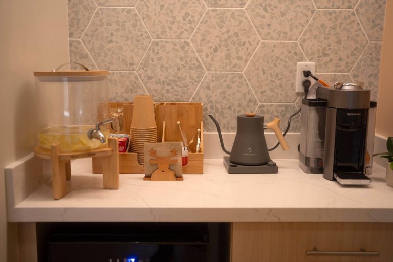 Kitchen counter with coffee maker and cups