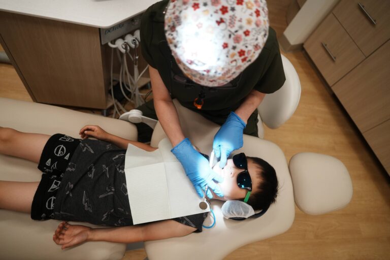 Child receiving dental checkup from dentist