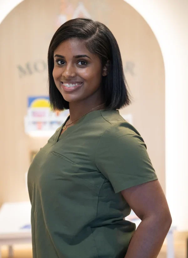 Smiling woman in green shirt at Montclair Pediatric Dentistry