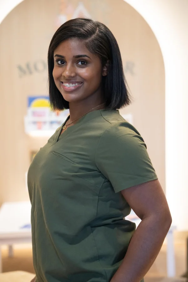 Smiling woman in green shirt at Montclair Pediatric Dentistry